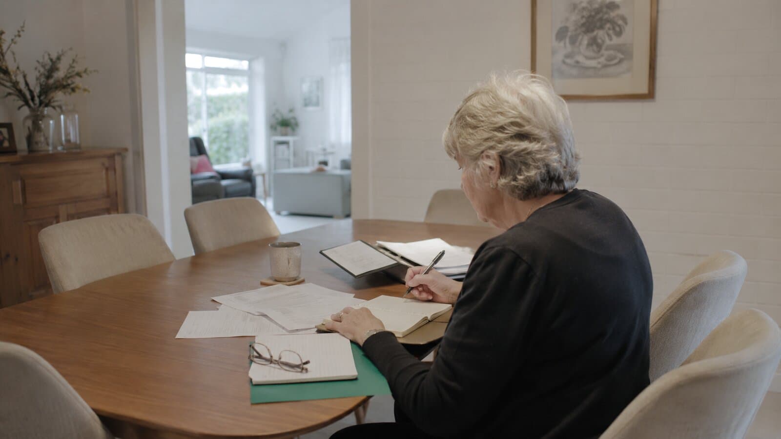 Early super release for a funeral: a person sorting financial paperwork at home