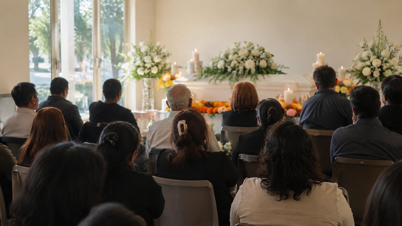 A Buddhist funeral service with an altar, candles and offerings