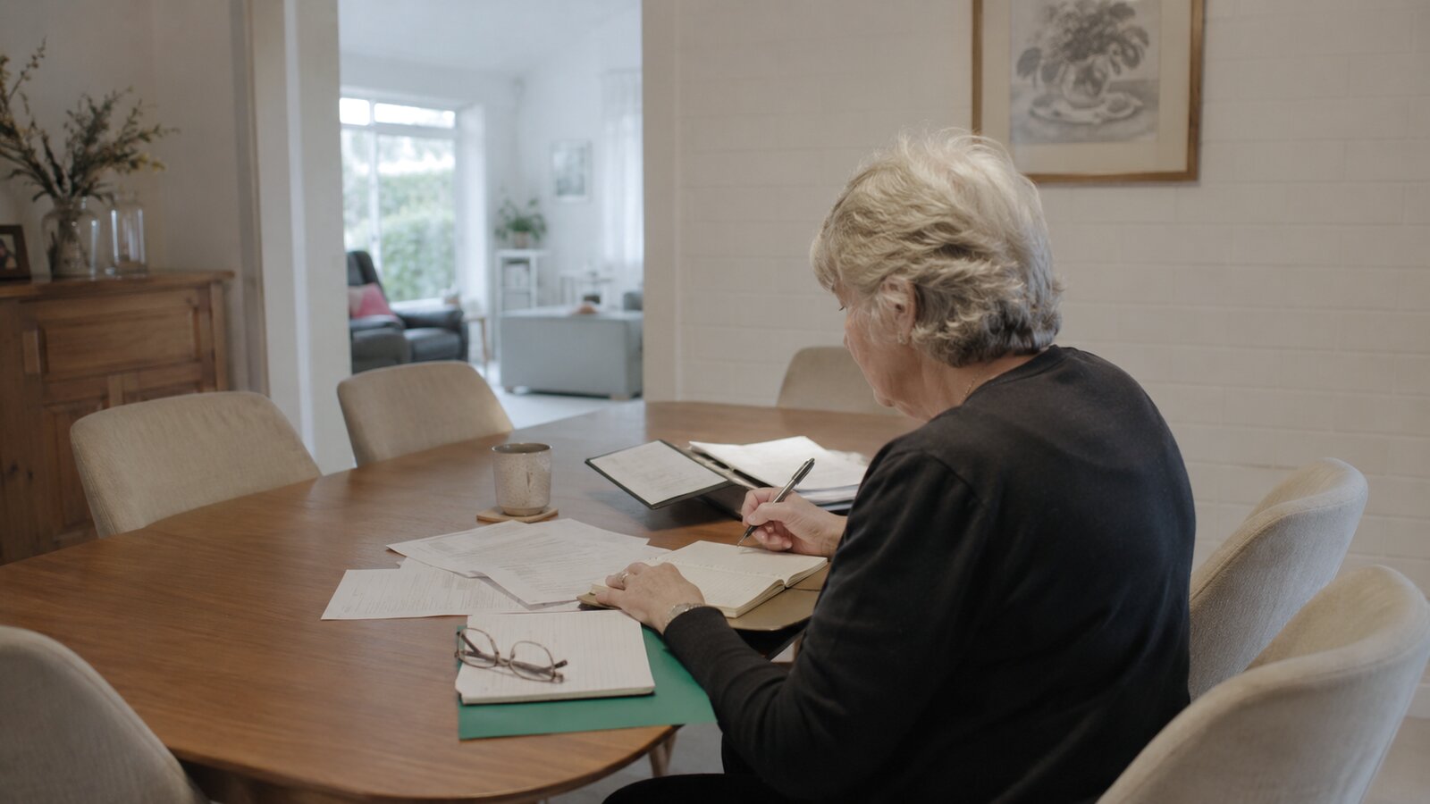 Early super release for a funeral: a person sorting financial paperwork at home