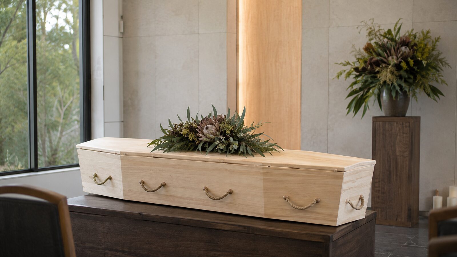 A natural biodegradable timber coffin with native flowers in a light-filled setting