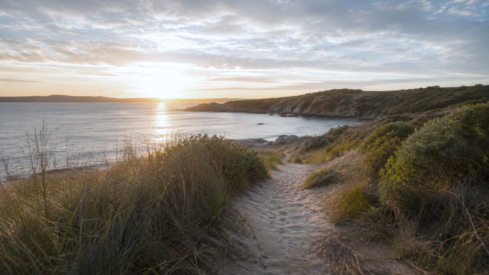 Repatriation to Australia: a coastal path leading toward the horizon at sunset